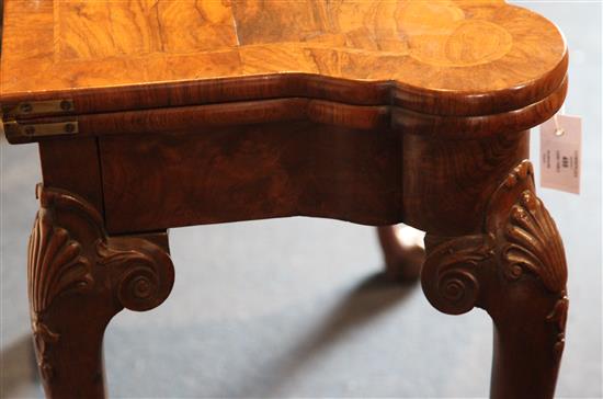 A fine George I figured walnut card table, W.2ft 10in. D.1ft 5in. H.2ft 5in.